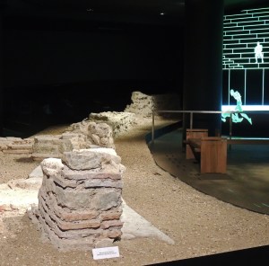 The arena wall with illustration on wall behind of what it would have looked like.