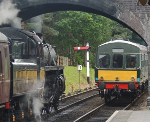 76084 leaqves Weybourne bound for Holt as DMU enters station bound for Sheringham